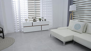 modern minimalist decor, bright living room, white sofa, sleek furniture, end table near window, contemporary interior, spacious room, modern living space, minimalist design, white curtains, gray floor tiles