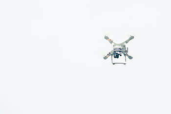 white quadcopter, drone, clear sky, minimalist capture, flying drone, quadcopter photography, aerial view, unmanned aerial vehicle, UAV, drone flight, sky photography