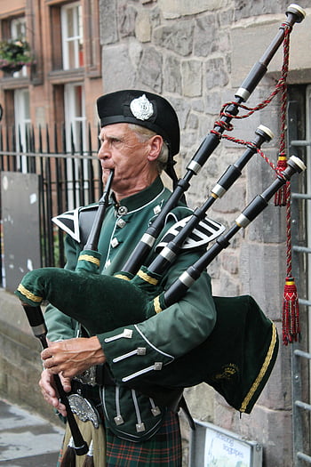 bagpipes, traditional Scottish uniform, elderly man, stone street, wind instrument, Scottish culture, bagpipe player, traditional attire, outdoor performance, street musician, Scottish heritage