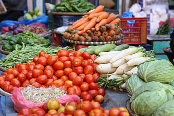 tomatoes, vegetables, street market, fresh produce, vibrant colors, carrots, cucumbers, cabbage, radishes, green beans, market display