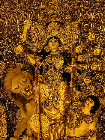 Goddess Durga, Kolkata, Durga Puja, intricately decorated idol, festival display, golden idol, lion mount, traditional art, cultural celebration, Hindu deity, ornate decoration