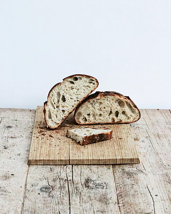slices of bread, cutting board, freshly baked sourdough, wooden cutting board, rustic charm, bread slices, sourdough bread, wooden board, baked bread, rustic bread, bread display