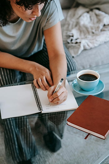young woman, writing notes, notebook, studying at home, cup of coffee, indoor setting, concentrated, notepad, home study, young lady, coffee cup