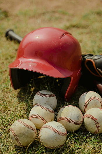 baseball sisak, baseball, füves terület, sportfelszerelés, piros sisak, sport témájú tervek, baseball felszerelés, kültéri sportok, baseball kiegészítők, sportfotózás, baseball pálya