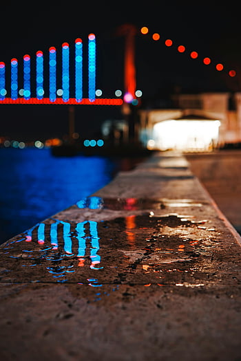 pavimentazione bagnata, ponte illuminato, luci vibranti, acqua riflettente, scena notturna, Istanbul, notte urbana, Riflessi colorati, vista sul lungomare, luci della città, fotografia notturna