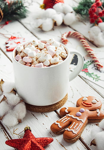 white ceramic mug, marshmallows, wooden surface, Christmas setting, hot cocoa, gingerbread, festive decorations, holiday scene, winter theme, cozy drink, Christmas treats
