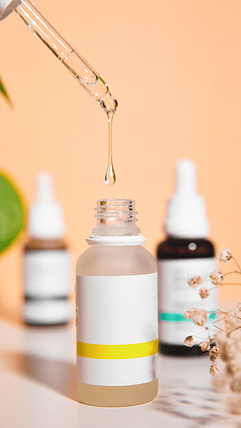 skincare serum, glass bottle, pipette, peach backdrop, beauty product, skincare care, beauty serum, dropper bottle, cosmetic product, natural skincare, beauty treatment