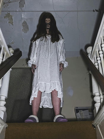 creepy person, white dress, eerie figure, staircase, Halloween vibe, spooky, haunted, ghostly, horror, dark atmosphere, ominous