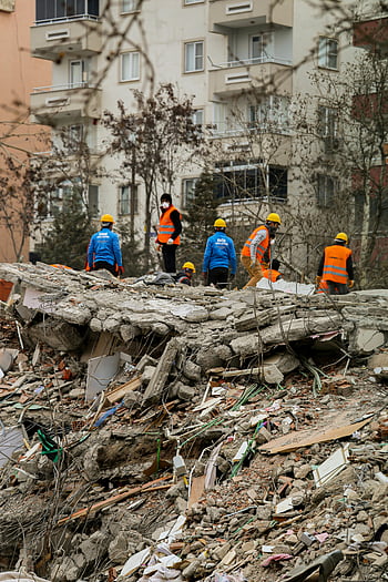 earthquake rescue, collapsed buildings, search operations, rescue team, disaster relief, emergency response, rubble, debris, safety gear, natural disaster, rescue workers
