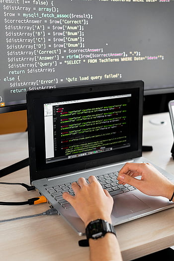 computer programming, coding, laptop, external monitor, programming code, desk, hands typing, software development, tech workspace, programmer, coding environment