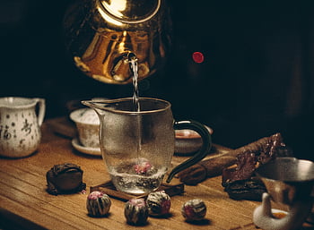 golden teapot, glass pitcher, pouring water, wooden table, elegant tea setup, tea ceremony, hot water, tea accessories, traditional tea, tea preparation, tea culture