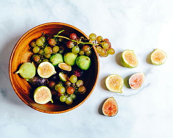 assorted fruits, green grapes, figs, marble surface, healthy eating, vibrant bowl, fresh fruits, wooden bowl, sliced figs, fruit bowl, marble table