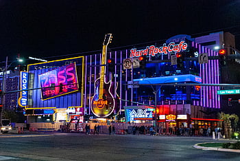 Hard Rock Cafe, Las Vegas Strip, neon lights, iconic landmarks, night scene, vibrant city, ABC Stores, Ross Dress for Less, guitar sign, Las Vegas nightlife, cityscape