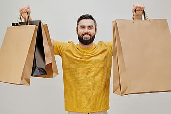man, yellow shirt, brown paper bags, shopping bags, happy man, joy of shopping, crew neck t-shirt, multiple shopping bags, smiling man, casual outfit, shopping experience