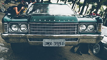 Green Chevrolet, vintage Chevrolet, car show, outdoor event, onlookers, classic car, license plate, JMX-3991, car design, automotive display, Chevrolet car