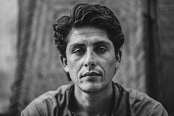 black and white portrait, young man, serious expression, black and white photography, portrait photography, man with serious face, black and white image, serious look, monochrome portrait, male portrait, black and white art