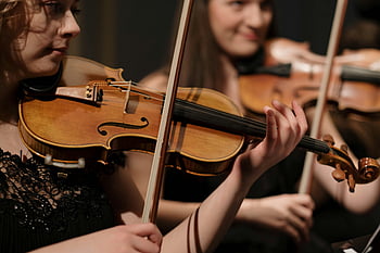 woman playing violin, classical music, musicians performing, violin performance, skill and concentration, musical instruments, string instruments, concert performance, live music, orchestra, violinist