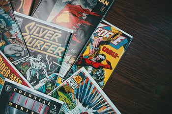 comic books, colorful covers, wooden surface, classic comics, Silver Surfer, vibrant assortment, flat display, floor, assorted comics, comic book collection, Marvel comics