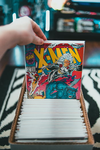 comic books, X-Men, collection, cardboard box, hand selecting, indoor, comic collection, comic book collection, X-Men comic, comic book, indoor collection