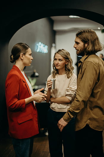 office discussion, modern office, colleagues talking, professional conversation, workplace interaction, business meeting, casual office, team discussion, office setting, professional setting, office environment