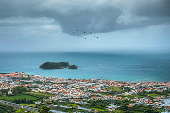 aerial photography, Vila Franca do Campo, Atlantic Ocean, dramatic clouds, village near water, coastal village, scenic view, ocean view, rural landscape, bird formation, cloudy sky