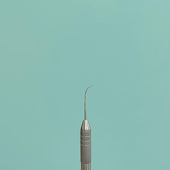 dental instrument, close-up, teal background, copy space, dental tool, medical equipment, dental hygiene, dental care, dental probe, dental scaler, dental pick