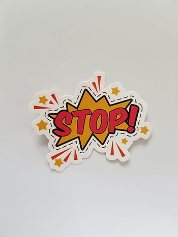 stop sticker, red and yellow, comic style, bright colors, gray background, star shape, stop sign, colorful design, comic book, sticker art, stop exclamation