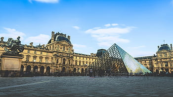 Louvre Museum, glass pyramid, Paris, clear blue sky, iconic building, France, tourist attraction, architectural landmark, modern design, European art, historical site