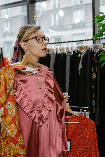 woman shopping, clothes boutique, stylish boutique, dress options, young woman, fashion store, clothing store, boutique shopping, dress shopping, fashion boutique, stylish clothing