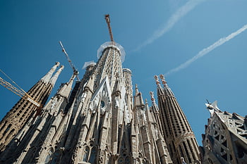 Sagrada Familia, Barcelona, aged church, blue sky, low-angle view, exterior, Gothic architecture, Antoni Gaudi, spires, construction cranes, historic building