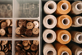 spools of threads, buttons, wooden buttons, thread spools, sewing supplies, close-up, container, neatly arranged, craft materials, sewing materials, textile supplies