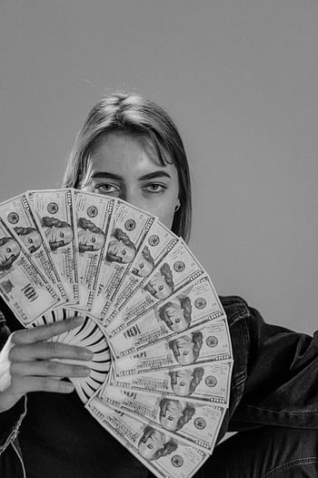 woman, face covering, hand fan, paper money, US dollar bills, black and white, portrait, young woman, money fan, partial face cover, monochrome photo