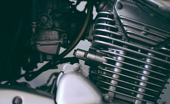 motorcycle engine, close-up, shiny, metal components, detailed, engine parts, mechanical details, motorcycle parts, engine showcase, engine components, motorcycle mechanics
