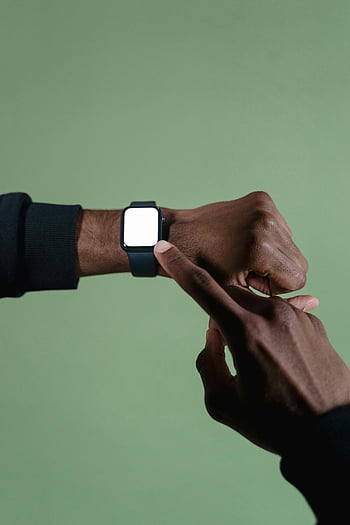 smartwatch, close-up, hands, pointing, wrist, green background, wearable technology, smart device, digital watch, modern gadget, tech accessory