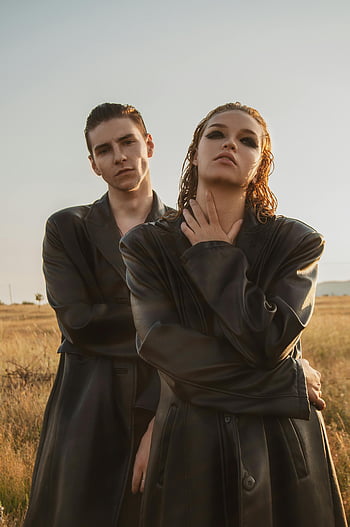 stylish couple, leather cloaks, field, fashionable young couple, black leather jackets, posing outdoors, outdoor fashion, couple in field, leather fashion, couple in leather, field fashion
