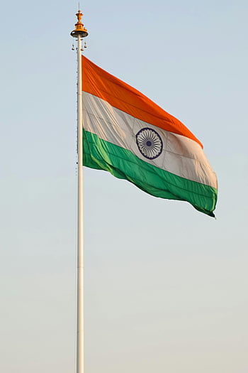 Indian national flag, waving flag, blue sky, clear day, patriotism, national pride, flagpole, tricolor flag, Ashoka Chakra, outdoor scene, India