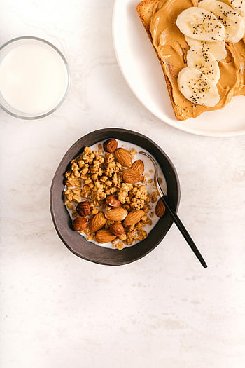 obilovin, mandle, černá keramická mísa, granola, banánovo-arašídový toast s máslem, výživná snídaně, pohled shora, mléko, Zdravé stravování, Ranní jídlo, Nápady na snídani