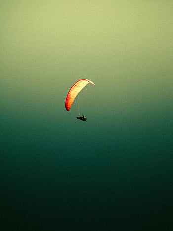 parachute flying, sky background, paraglider soaring, thrill of flight, dramatic gradient, aerial adventure, outdoor sports, extreme sports, skydiving, adventure photography, paragliding