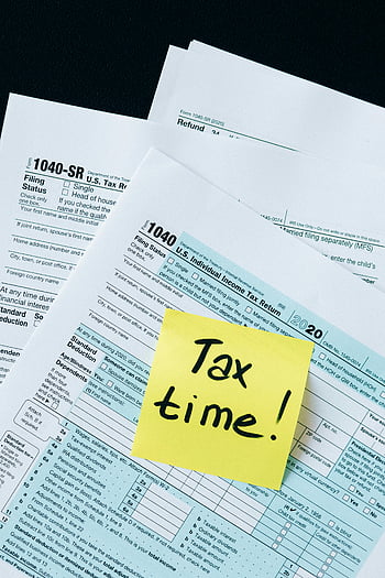tax documents, IRS 1040 forms, tax time, filing reminder, handwritten note, tax forms, tax return, individual income tax, tax preparation, tax season, tax filing