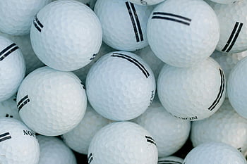 golf balls, close-up photography, white golf balls, sports themes, golf enthusiasts, detailed shot, pile of golf balls, golf equipment, golf accessories, golf imagery, golf ball texture