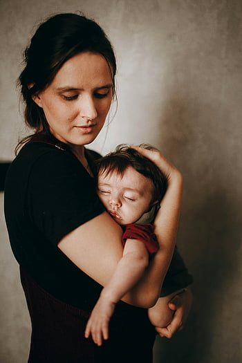 mother, sleeping baby, maternal love, gentle hold, serene scene, close embrace, cute baby, motherhood, tender moment, family bond, warmth