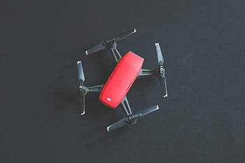 red DJI Spark, drone, vibrant red, black background, modern technology, DJI drone, top view, red drone, technology, black surface, aerial photography