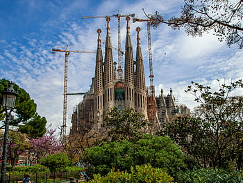 Sagrada Familia, Barcelona, Spain, Antoni Gaudí, basilica, greenery, iconic architecture, construction cranes, religious building, Gothic style, masterpiece