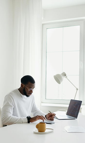remote work, home office, modern workspace, laptop use, productive, natural light, clean office, minimalist design, work from home, engaged, professional