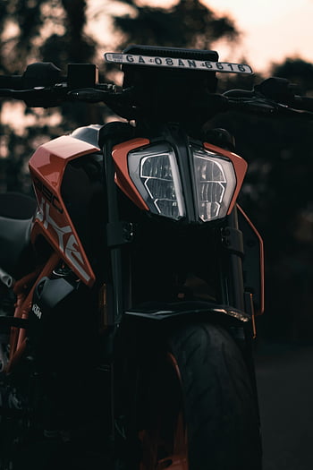 KTM 390 Duke, close-up photography, motorcycle headlight, front wheel, modern design, detailed shot, KTM motorcycle, close-up image, motorcycle details, headlight design, front wheel close-up