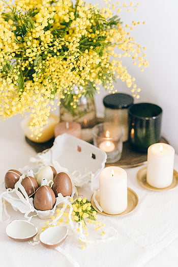 Easter, chocolate eggs, burning candles, mimosa flowers, elegant scene, table setting, spring decor, festive table, Easter decoration, Easter eggs, candlelight ambiance