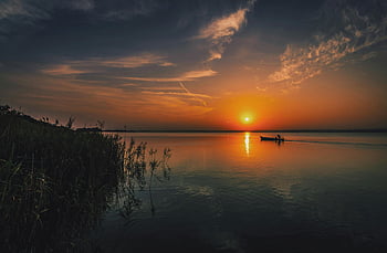 sunset, boat, calm waters, serene scene, tranquil scene, person on boat, sunset reflection, silhouette boat, peaceful sunset, nature photography, evening landscape