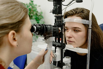 female optometrist, eye examination, advanced ophthalmic equipment, medical laboratory, clinic, patient vision, eye health, ophthalmology, eye care, medical professional, eye test