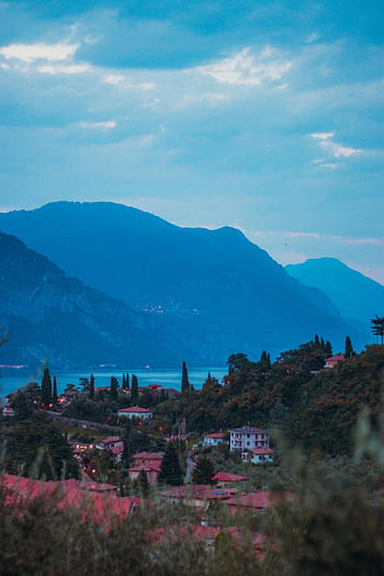 Malcesine, Lake Garda, surrounding mountains, twilight, panoramic view, cloudy sky, Italian landscape, scenic view, evening scenery, natural beauty, alpine region