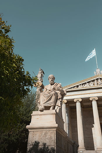 Plato statue, National Library of Greece, clear blue sky, Greek flag, ancient architecture, marble statue, classical sculpture, Athens Greece, cultural landmark, historical monument, outdoor sculpture